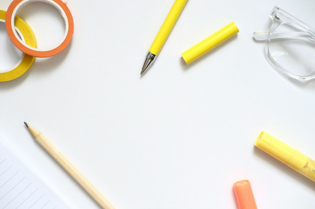 Notebook, pen and sheets with notes on a desk